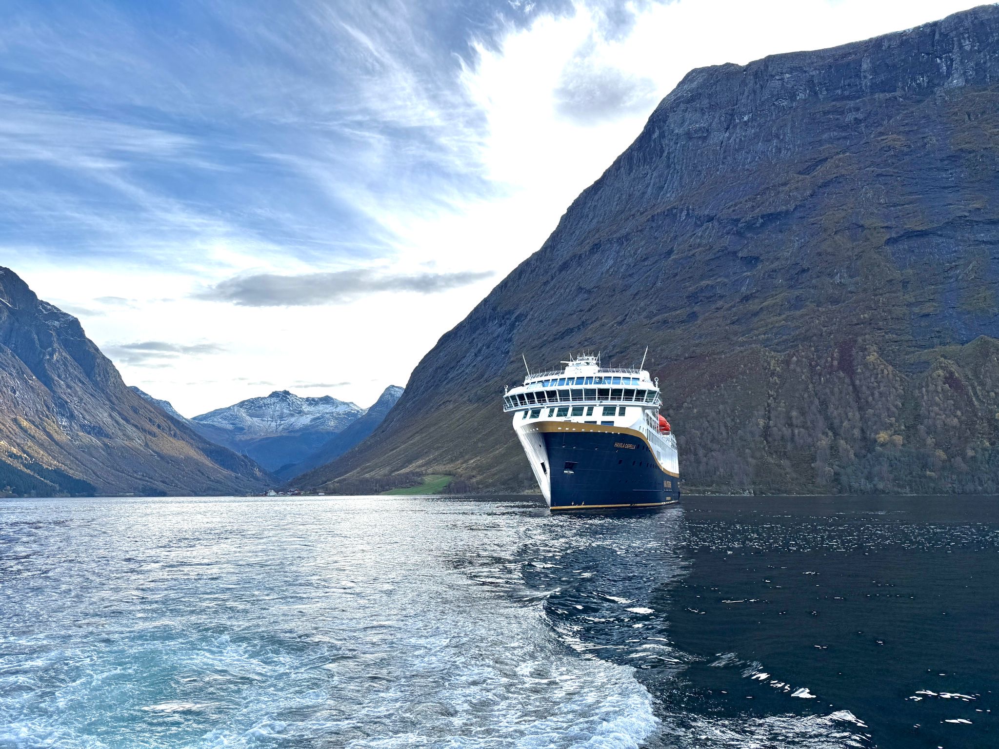 Cruise ship sailing through a Norwegian fjord